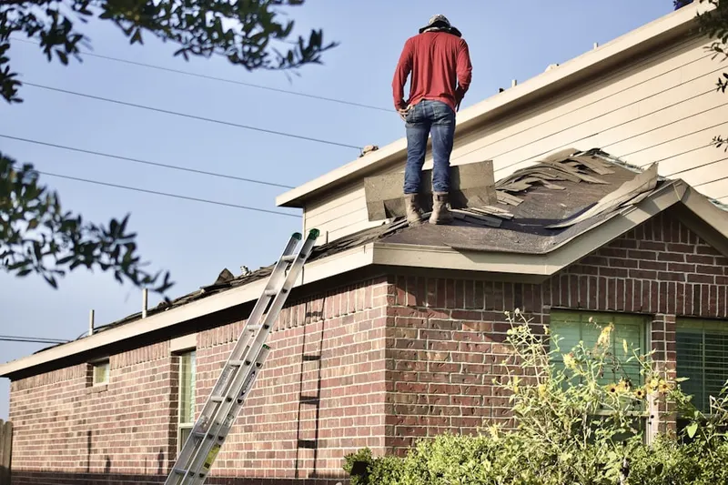 Professional roofer working on a residential roof in Zionsville